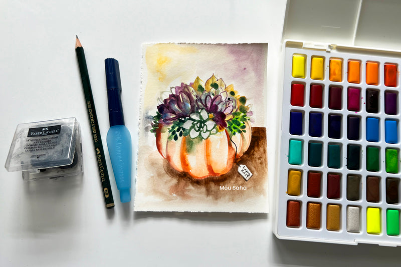 Watercolor succulent pumpkin painting with art supplies