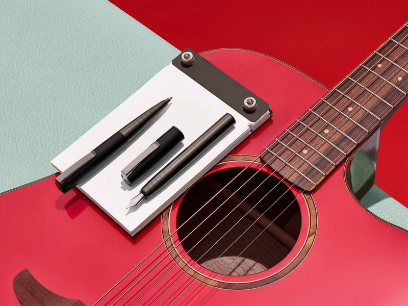 LOOM Fine Writing Collection pens on a guitar